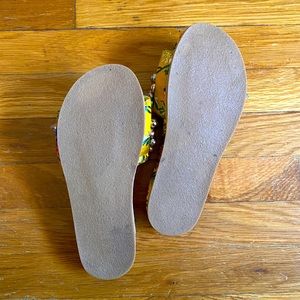 A beaded, multicolored strapless sandal.